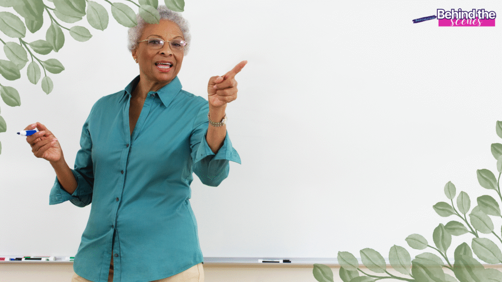 An older woman wearing glasses and a teal shirt stands in front of a whiteboard, holding a marker and pointing forward. Leafy borders frame the image, and Behind the scenes is written in the upper right corner. Jobs for teachers leaving education